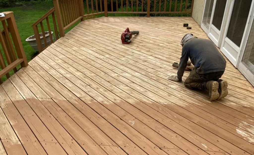 Deck restoration services working on a wooden deck