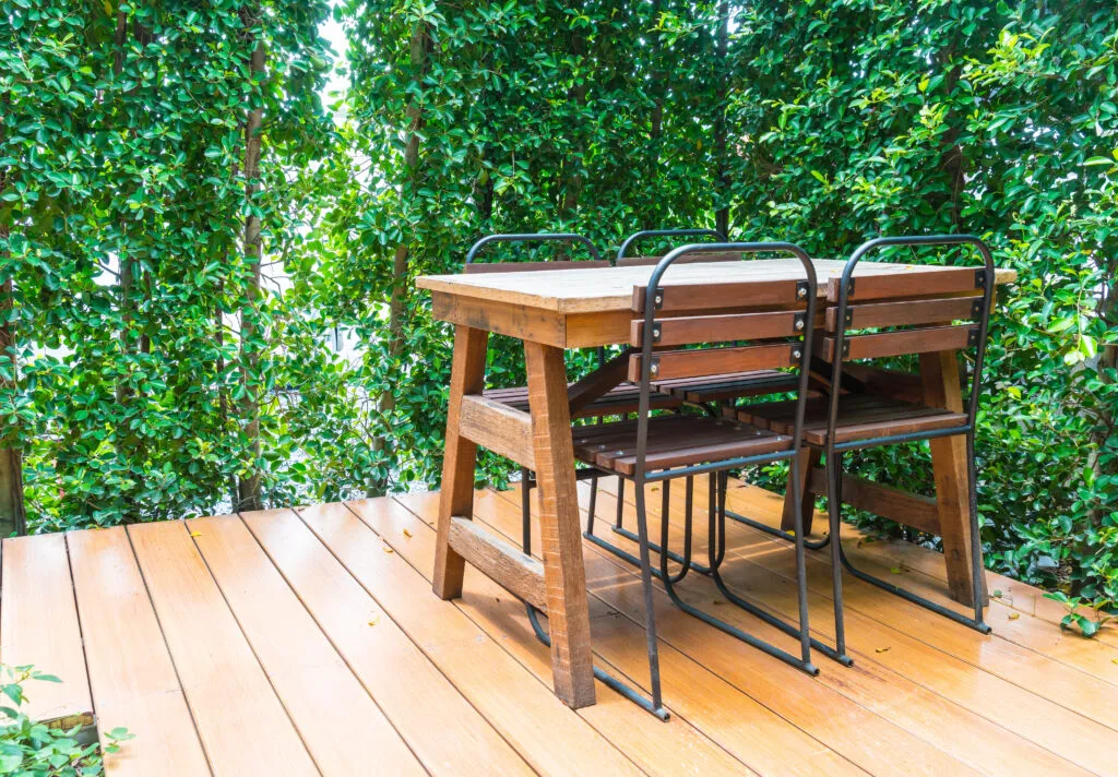 wooden deck with shairs and a wooden table