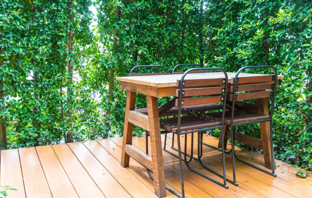 wooden deck with shairs and a wooden table