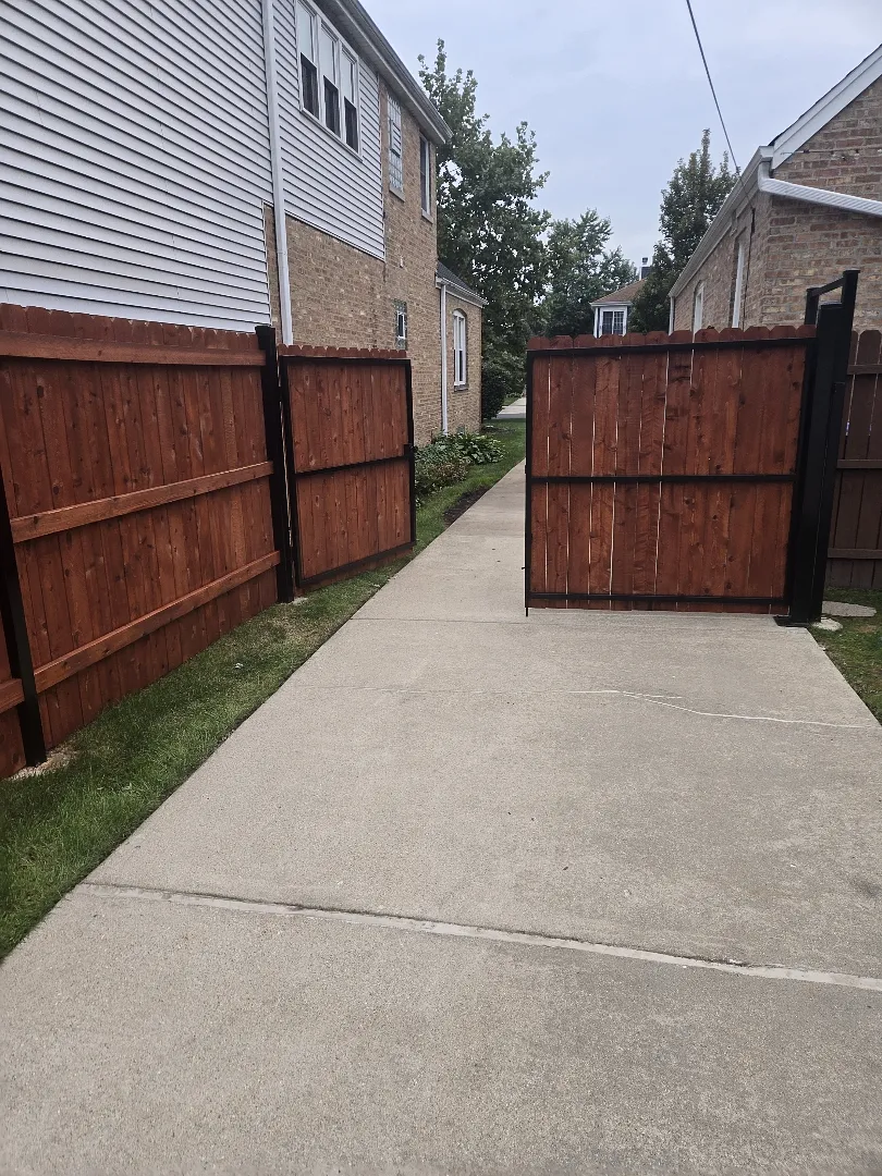 Cedar privacy fence and driveway gate sealed with TWP 1500 Rustic semi-transparent stain in Chicago